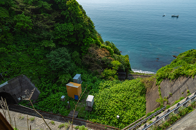 急勾配の崖下に辺加牛の浜と漁船が見えていた